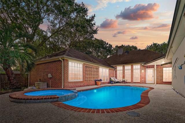 23314 Dunhill Ct, Katy, TX 77494 - pool at dusk with a pool with connected hot tub