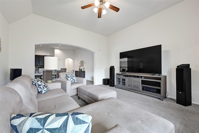 15023 Winter Valley Ct, Humble, TX 77396 - living room featuring arched walkways, a ceiling fan, light carpet, and high vaulted ceiling