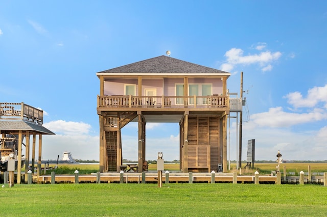 1229 N Stingaree Dr, Crystal Beach, TX 77650 - back of property with a yard and a shingled roof