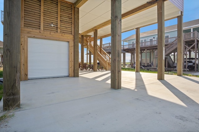 1229 N Stingaree Dr, Crystal Beach, TX 77650 - view of patio with stairway and an attached garage