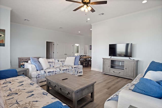 1229 N Stingaree Dr, Crystal Beach, TX 77650 - living area with light wood finished floors, ceiling fan, crown molding, and recessed lighting