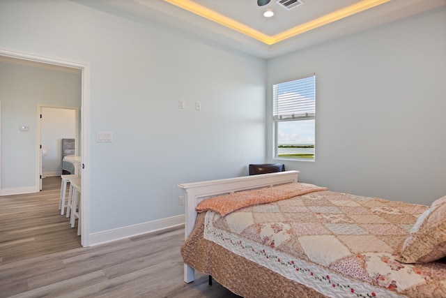 1229 N Stingaree Dr, Crystal Beach, TX 77650 - bedroom featuring wood finished floors, a raised ceiling, and recessed lighting