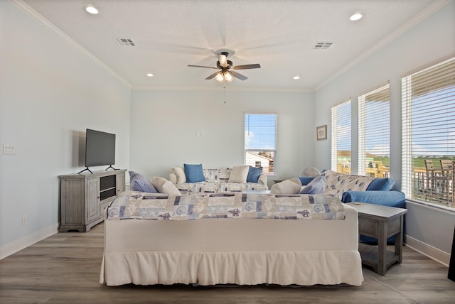 1229 N Stingaree Dr, Crystal Beach, TX 77650 - living area featuring crown molding, ceiling fan, recessed lighting, and light wood finished floors