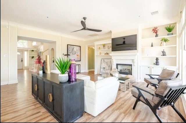 20522 Riverside Pines Dr, Houston, TX 77346 - living room with a ceiling fan, light wood-style flooring, and a fireplace