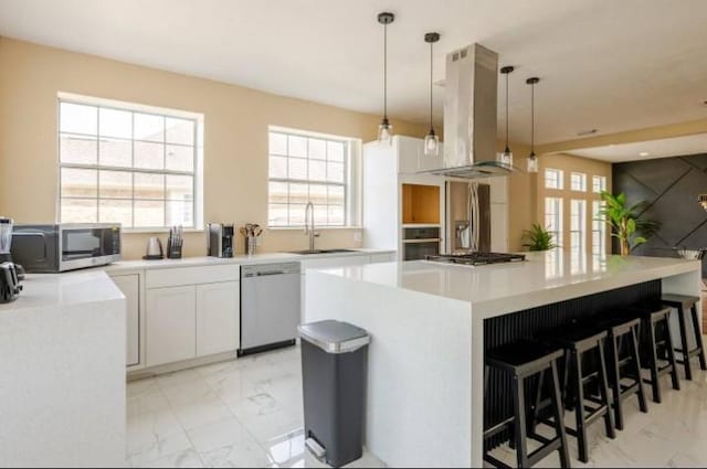 20522 Riverside Pines Dr, Houston, TX 77346 - kitchen featuring stainless steel appliances, island range hood, light marble finish floors, a center island, and plenty of natural light
