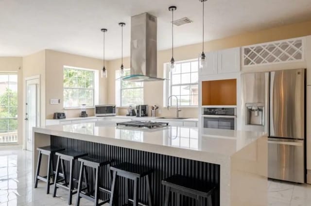 20522 Riverside Pines Dr, Houston, TX 77346 - kitchen featuring stainless steel appliances, exhaust hood, light marble finish floors, a spacious island, and light countertops