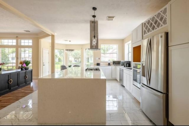 20522 Riverside Pines Dr, Houston, TX 77346 - kitchen with appliances with stainless steel finishes, light marble finish flooring, ventilation hood, a center island, and light countertops