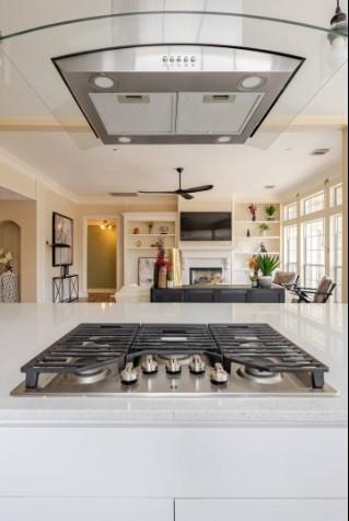 20522 Riverside Pines Dr, Houston, TX 77346 - kitchen with ceiling fan, a fireplace, and light countertops
