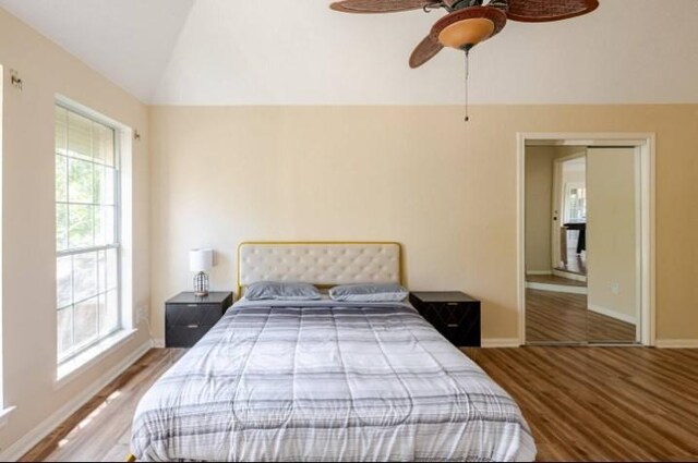 20522 Riverside Pines Dr, Houston, TX 77346 - bedroom with vaulted ceiling, wood finished floors, multiple windows, and ceiling fan