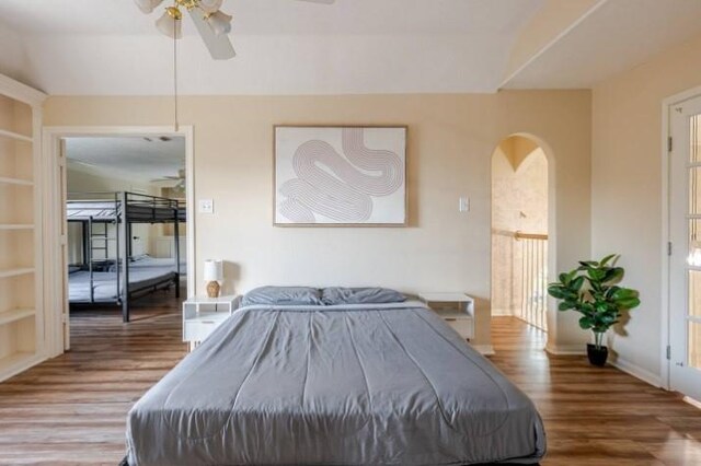 20522 Riverside Pines Dr, Houston, TX 77346 - bedroom featuring wood finished floors, arched walkways, and a ceiling fan