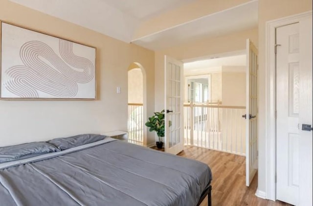 20522 Riverside Pines Dr, Houston, TX 77346 - bedroom featuring wood finished floors and arched walkways