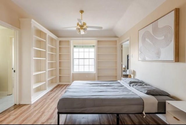 20522 Riverside Pines Dr, Houston, TX 77346 - bedroom featuring wood finished floors, vaulted ceiling, and a ceiling fan