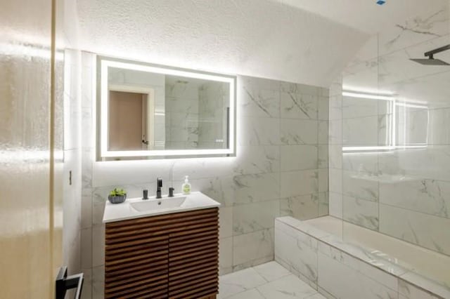 20522 Riverside Pines Dr, Houston, TX 77346 - bathroom featuring vanity, marble finish floors, a shower, and tile walls