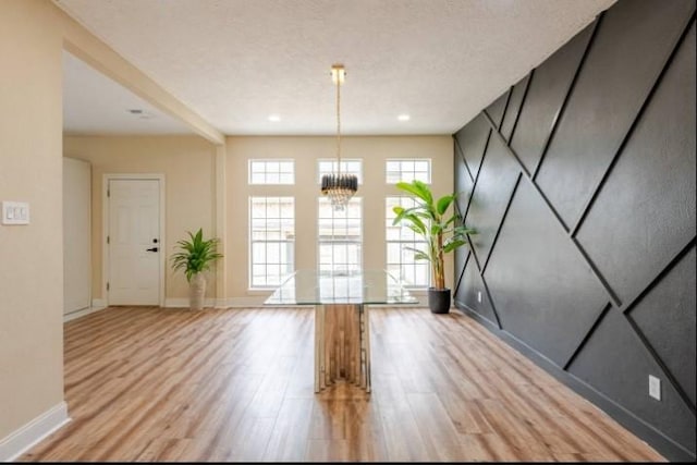 20522 Riverside Pines Dr, Houston, TX 77346 - empty room featuring light wood-style flooring and a chandelier