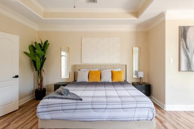 20522 Riverside Pines Dr, Houston, TX 77346 - bedroom featuring a raised ceiling, wood finished floors, and crown molding