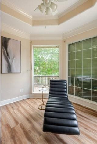 20522 Riverside Pines Dr, Houston, TX 77346 - living area with ornamental molding, a raised ceiling, ceiling fan, and wood finished floors