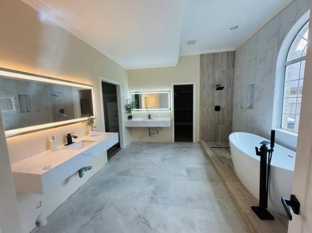 20522 Riverside Pines Dr, Houston, TX 77346 - full bath with a freestanding bath, a tile shower, a walk in closet, vanity, and ornamental molding