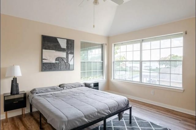 20522 Riverside Pines Dr, Houston, TX 77346 - bedroom featuring wood finished floors, lofted ceiling, and ceiling fan