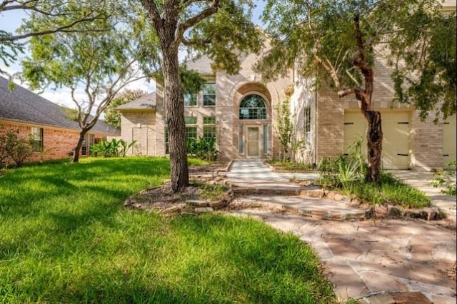 20522 Riverside Pines Dr, Houston, TX 77346 - view of front of house featuring brick siding, a front yard, and a garage