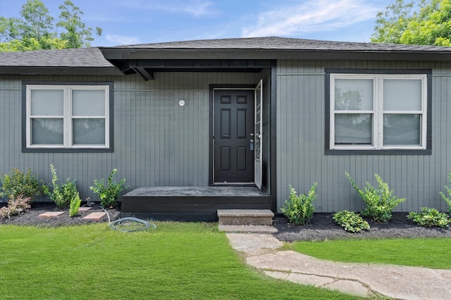 3626 Sparrow St, Houston, TX 77051 - doorway to property with a shingled roof and a lawn