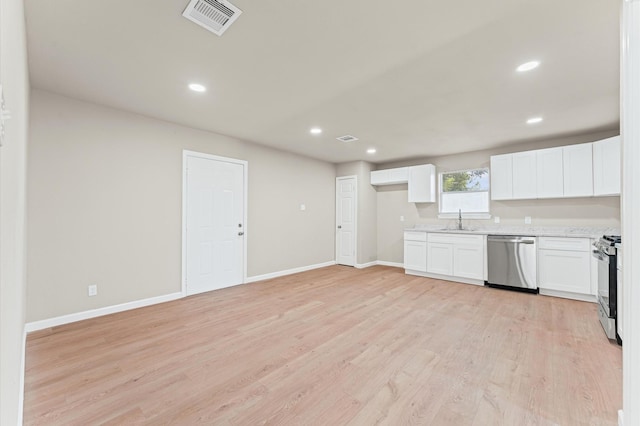 3626 Sparrow St, Houston, TX 77051 - kitchen with appliances with stainless steel finishes, light wood-style flooring, white cabinets, recessed lighting, and light stone countertops