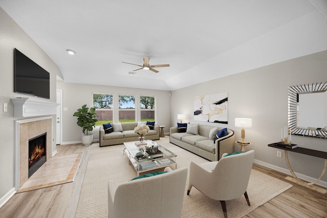 21002 Pineda Cir, Richmond, TX 77406 - living room with wood finished floors, a ceiling fan, and a fireplace