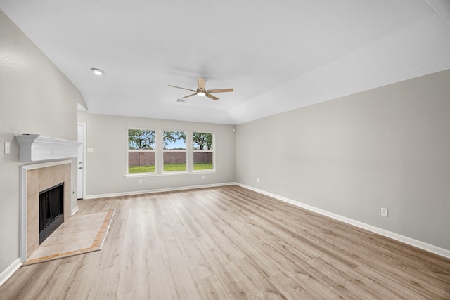 21002 Pineda Cir, Richmond, TX 77406 - unfurnished living room featuring ceiling fan, light wood finished floors, and a tiled fireplace