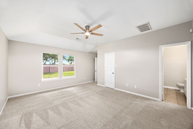 21002 Pineda Cir, Richmond, TX 77406 - unfurnished bedroom with carpet flooring, connected bathroom, a ceiling fan, and vaulted ceiling