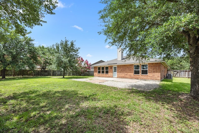 21002 Pineda Cir, Richmond, TX 77406 - back of house with a patio, a chimney, brick siding, and a fenced backyard