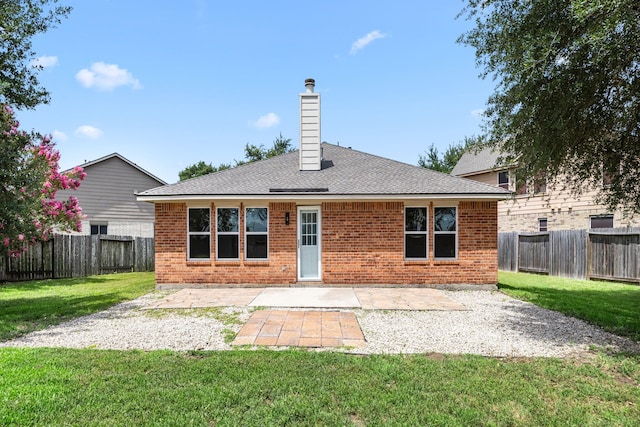 21002 Pineda Cir, Richmond, TX 77406 - back of property featuring a fenced backyard, a patio, brick siding, and a chimney