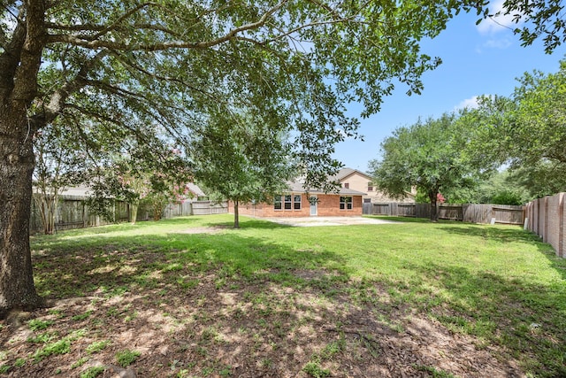 21002 Pineda Cir, Richmond, TX 77406 - fenced backyard featuring a patio area