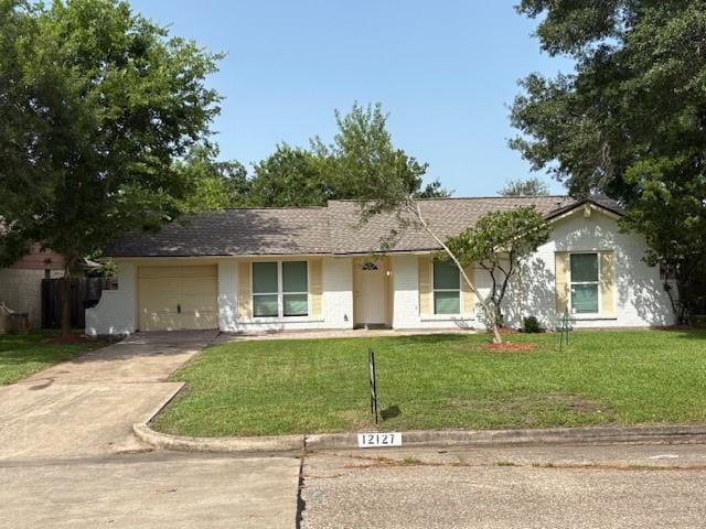 12127 Rhinebeck Dr, Houston, TX 77089 - ranch-style house featuring concrete driveway, a front yard, and a garage