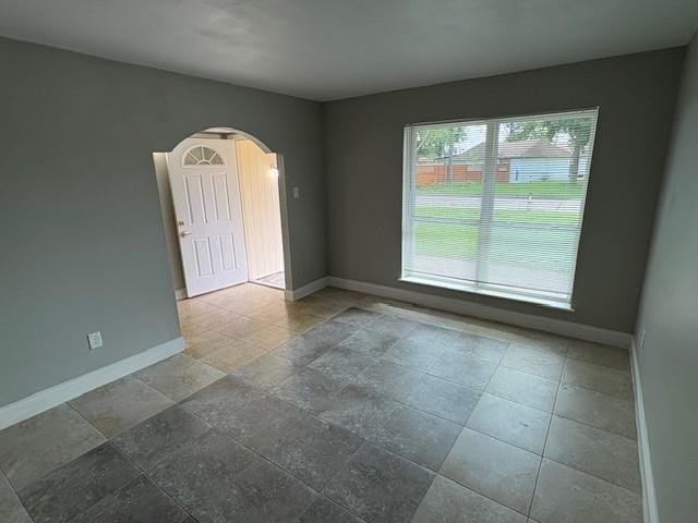 12127 Rhinebeck Dr, Houston, TX 77089 - spare room with arched walkways and baseboards
