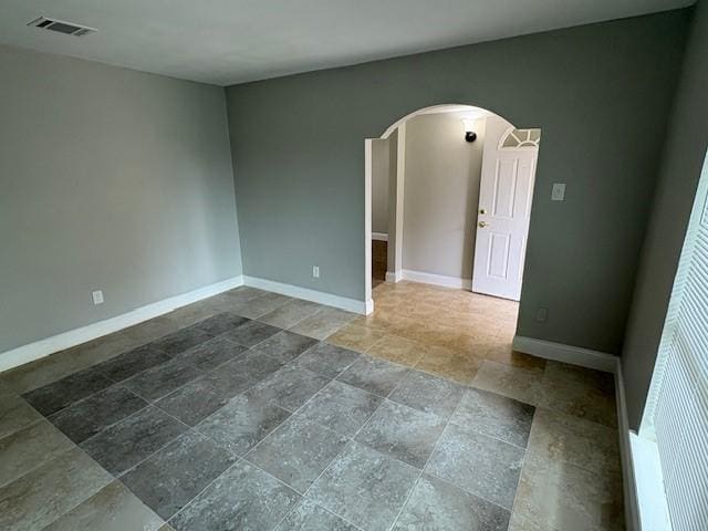 12127 Rhinebeck Dr, Houston, TX 77089 - empty room featuring arched walkways and stone tile flooring