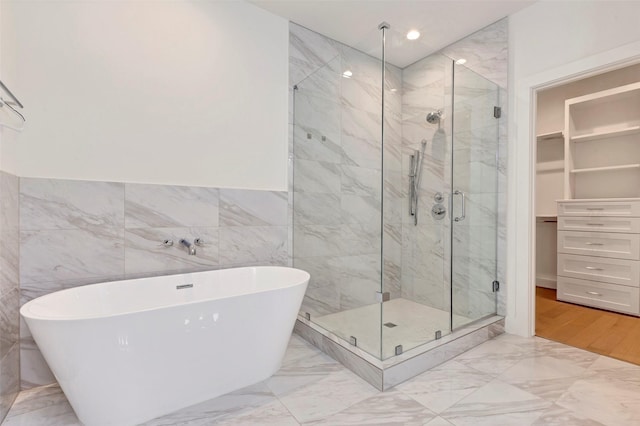 1740 Ojeman Point Ln, Houston, TX 77055 - bathroom with a stall shower, a soaking tub, marble finish floors, a walk in closet, and tile walls