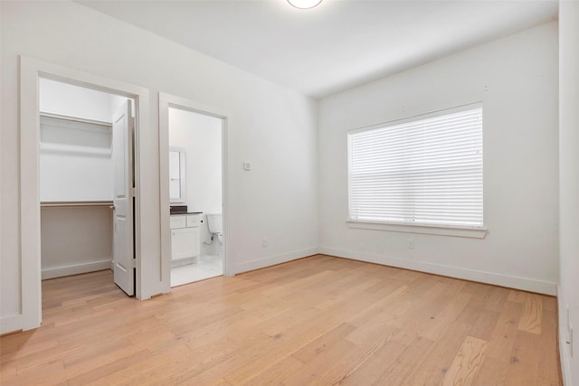1740 Ojeman Point Ln, Houston, TX 77055 - unfurnished bedroom featuring light wood finished floors, a spacious closet, a closet, and ensuite bathroom