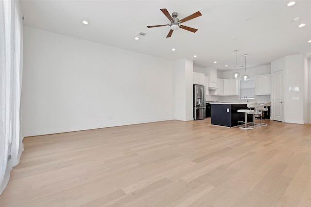 1740 Ojeman Point Ln, Houston, TX 77055 - unfurnished living room featuring recessed lighting, light wood-style flooring, and a ceiling fan
