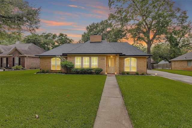 116 April Wind Dr E, Montgomery, TX 77356 - view of front of home featuring brick siding, a chimney, and roof with shingles