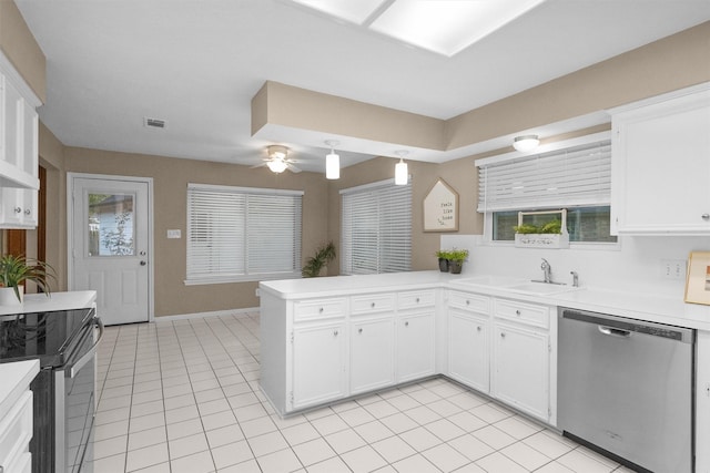 116 April Wind Dr E, Montgomery, TX 77356 - kitchen featuring stainless steel appliances, a peninsula, light tile patterned floors, and light countertops