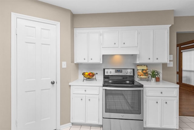 116 April Wind Dr E, Montgomery, TX 77356 - kitchen with electric stove, custom exhaust hood, white cabinets, light countertops, and light tile patterned floors