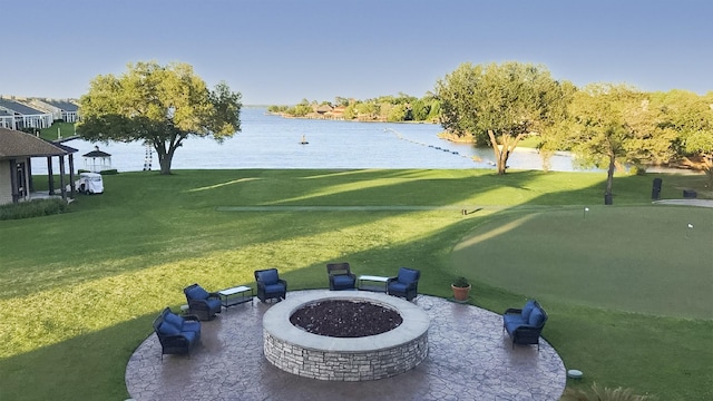 116 April Wind Dr E, Montgomery, TX 77356 - view of green lawn featuring a fire pit and a water view