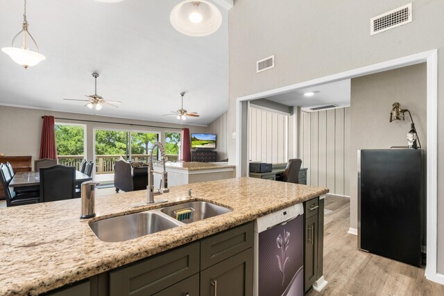 17 Lakeview Vlg, Montgomery, TX 77356 - kitchen with white dishwasher, light wood-style flooring, freestanding refrigerator, light stone counters, and ceiling fan
