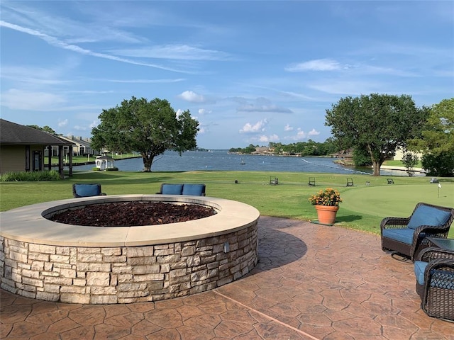 17 Lakeview Vlg, Montgomery, TX 77356 - view of patio featuring a putting green, a water view, and an outdoor fire pit