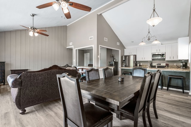 17 Lakeview Vlg, Montgomery, TX 77356 - dining area featuring a ceiling fan, light wood-style flooring, and high vaulted ceiling