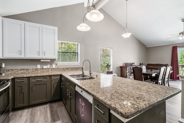 17 Lakeview Vlg, Montgomery, TX 77356 - kitchen with white dishwasher, light wood-style flooring, a peninsula, white cabinets, and beam ceiling
