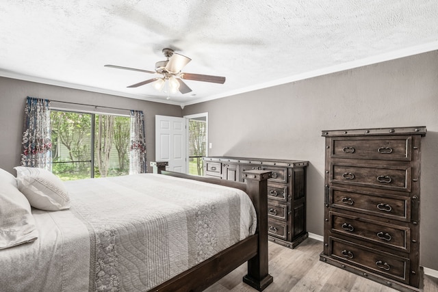 17 Lakeview Vlg, Montgomery, TX 77356 - bedroom with light wood finished floors, ornamental molding, a textured ceiling, a ceiling fan, and access to exterior