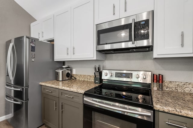 17 Lakeview Vlg, Montgomery, TX 77356 - kitchen featuring stainless steel appliances, white cabinets, and light stone counters