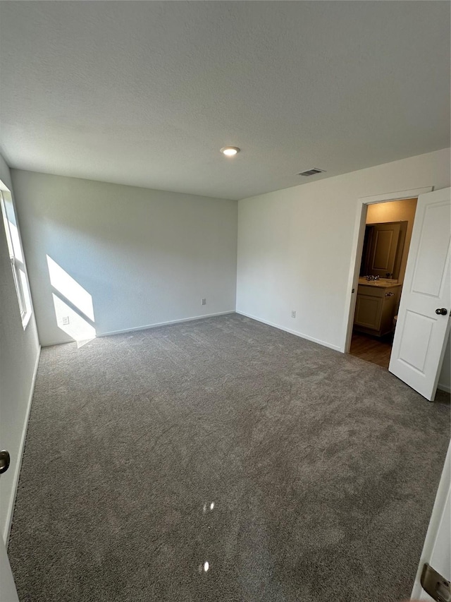 1611 Winwood Dr, Conroe, TX 77303 - spare room featuring dark colored carpet and baseboards