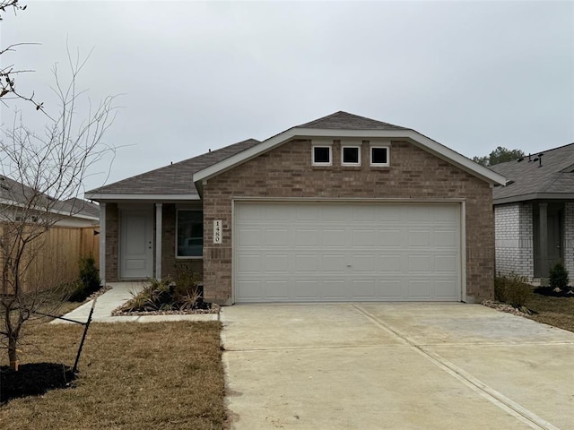 1611 Winwood Dr, Conroe, TX 77303 - single story home with brick siding, driveway, a shingled roof, and a garage