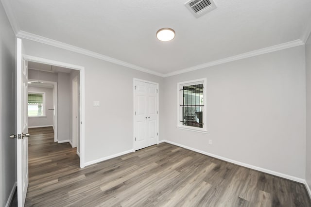 3603 Idaho St, Houston, TX 77021 - unfurnished bedroom with wood finished floors, crown molding, attic access, and a closet